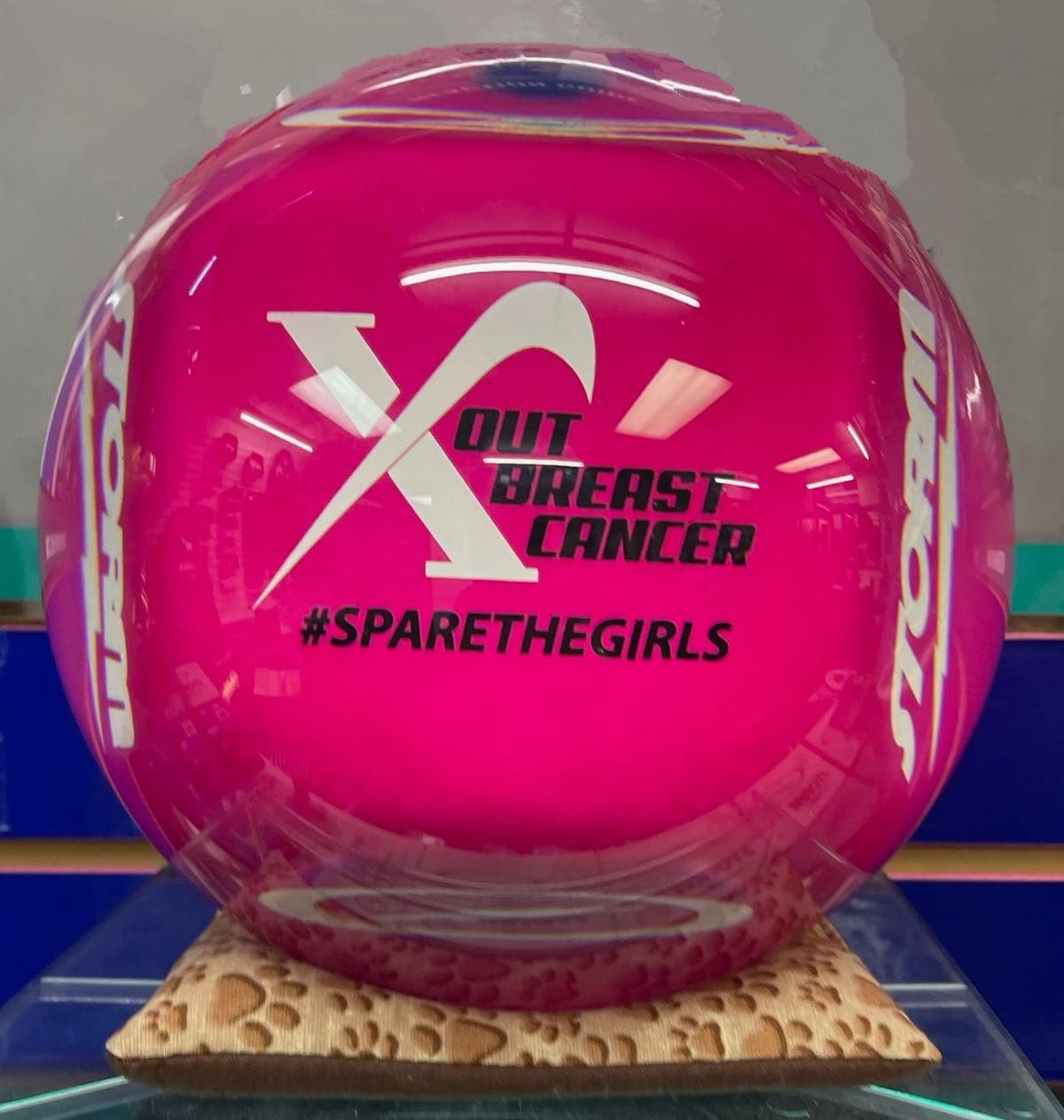 The raffle prize is a bowling ball with the charity logo